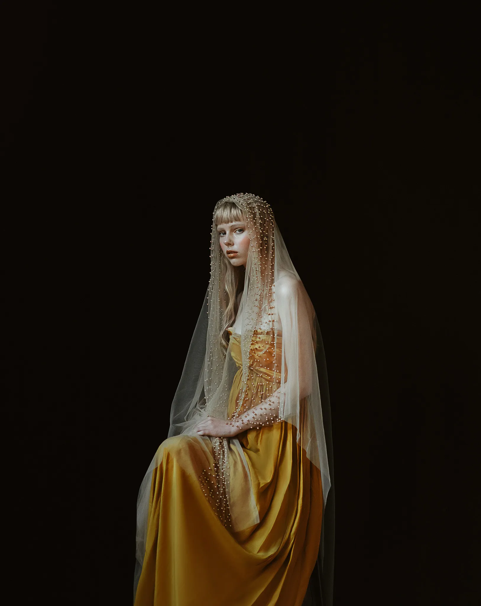 Sculptural textile garment photographed against black
