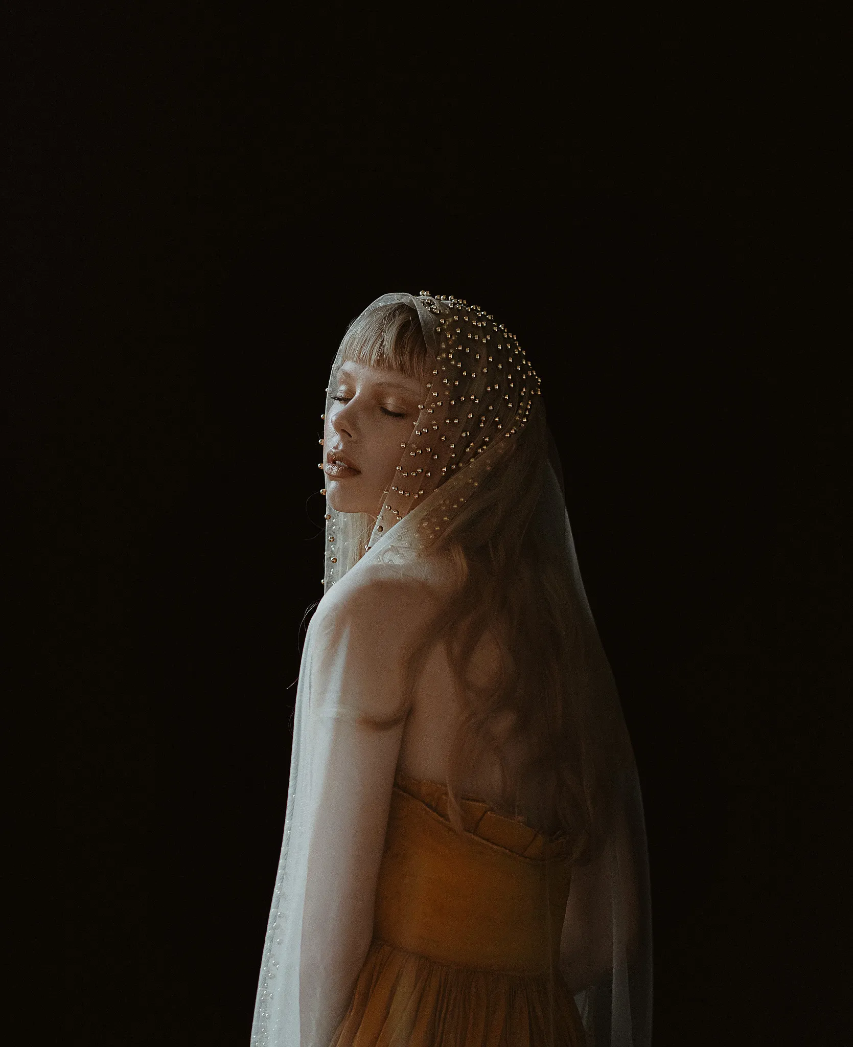 Sculptural textile garment photographed against black